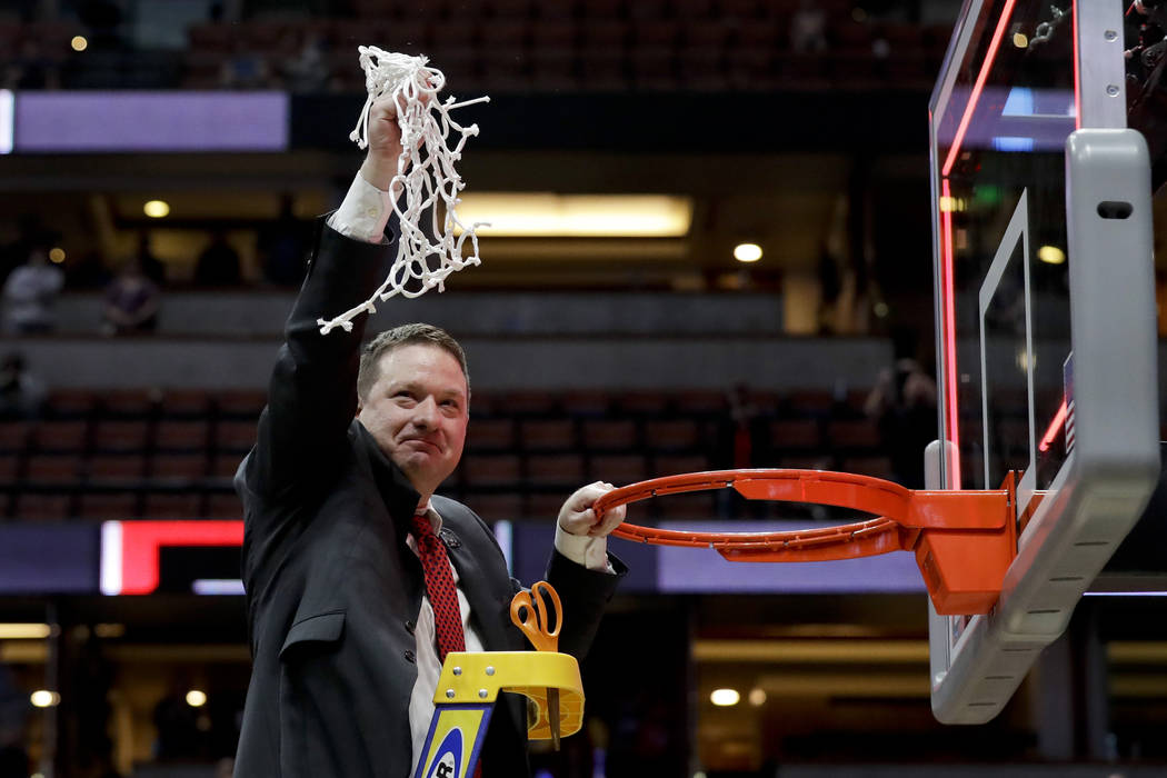 Texas Tech coach Chris Beard holds up the net after the team's win over Gonzaga in the West Reg ...