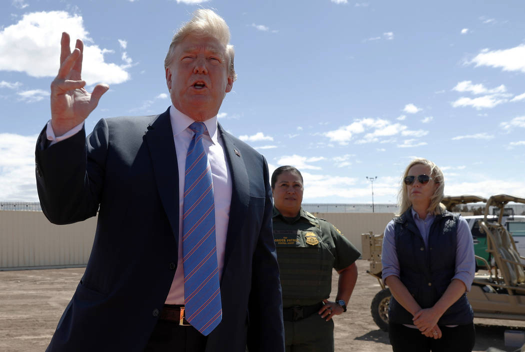 President Donald Trump speaks as he visits a new section of the border wall with Mexico in Cale ...