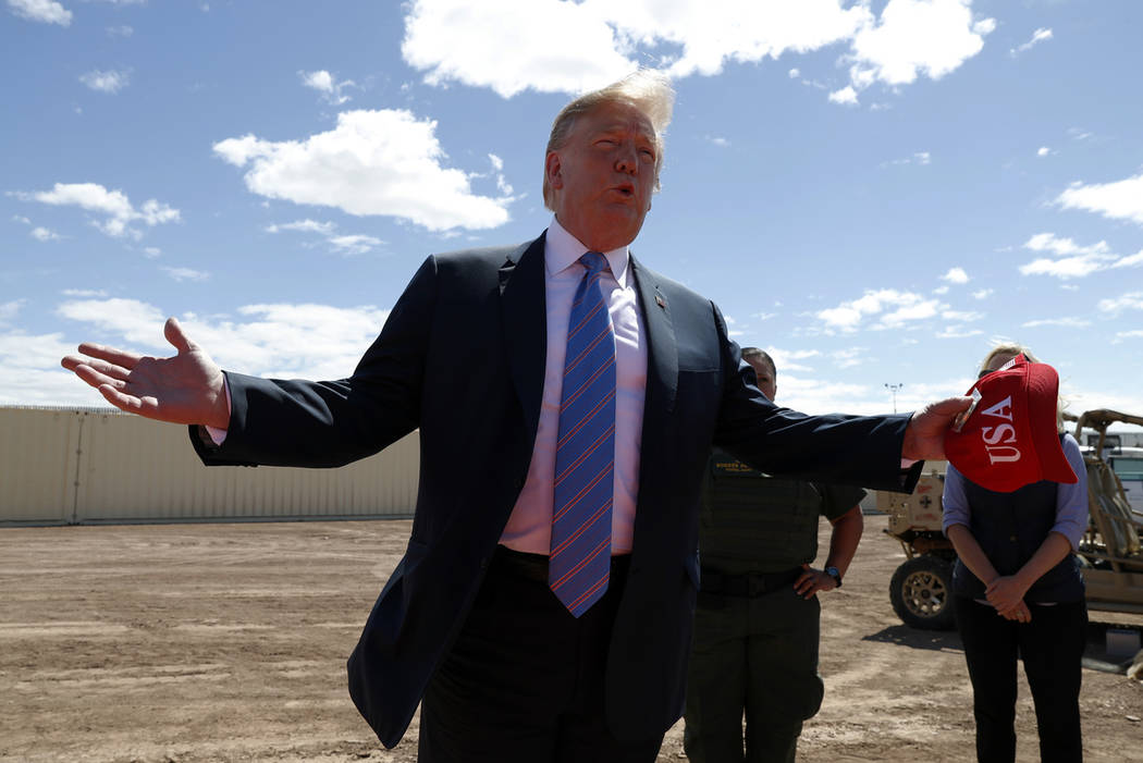 President Donald Trump visits a new section of the border wall with Mexico in Calexico, Calif., ...