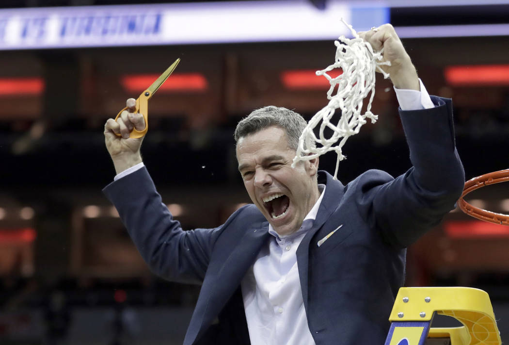 Virginia head coach Tony Bennett celebrates after defeating Purdue 80-75 in overtime of the men ...