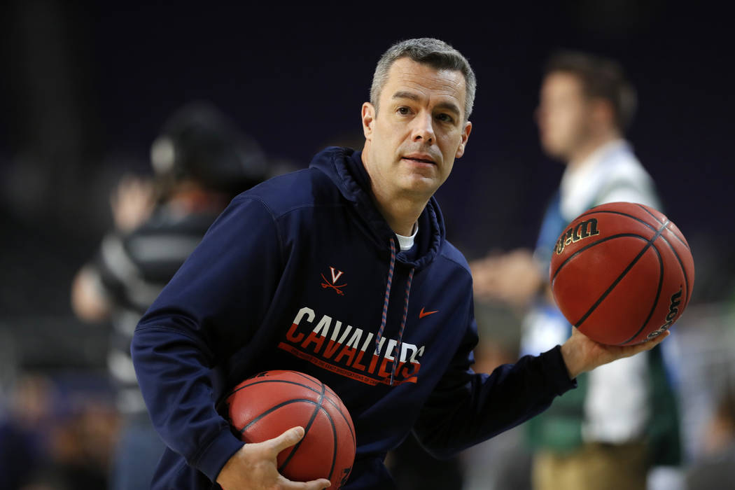 Virginia head coach Tony Bennett passes the ball during a practice session for the semifinals o ...