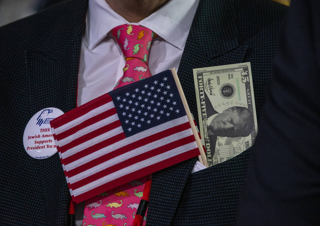 An attendee is decked out as President Donald J. Trump addresses the Republican Jewish Coalitio ...