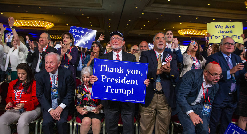 Attendees applaud President Donald J. Trump while he addresses the Republican Jewish Coalition ...