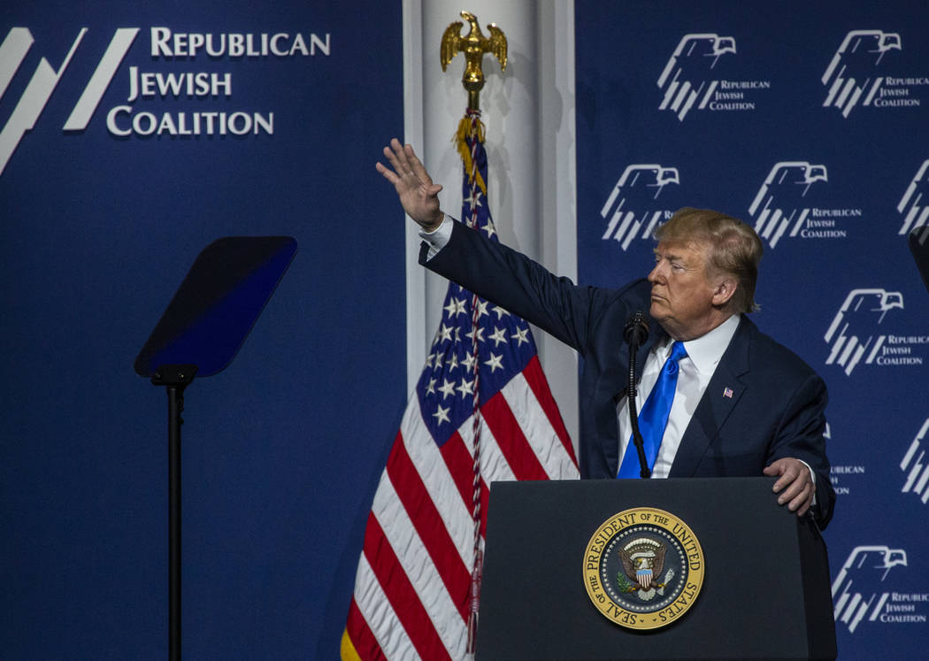 President Donald J. Trump waves to an invited guest as he addresses the Republican Jewish Coali ...