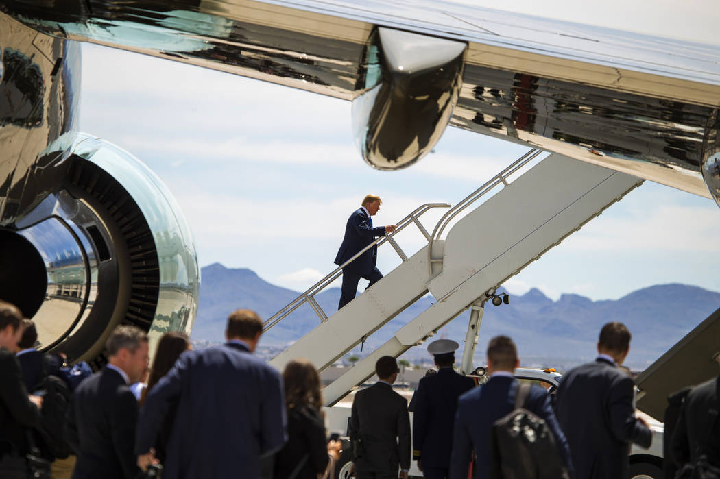 President Donald J. Trump climbs the stairs as he readies to depart from McCarran International ...