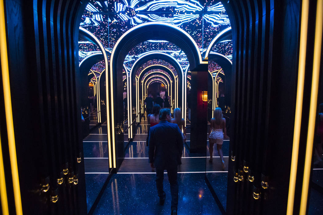 Attendees walk through a mirrored hallway to enter Kaos, the new dayclub and nightclub at the P ...