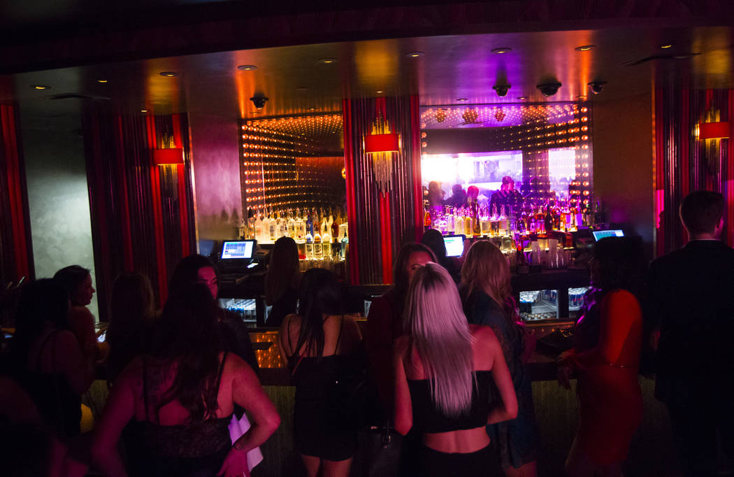 Attendees line up for drinks at a bar during the grand opening weekend of Kaos, the new dayclub ...