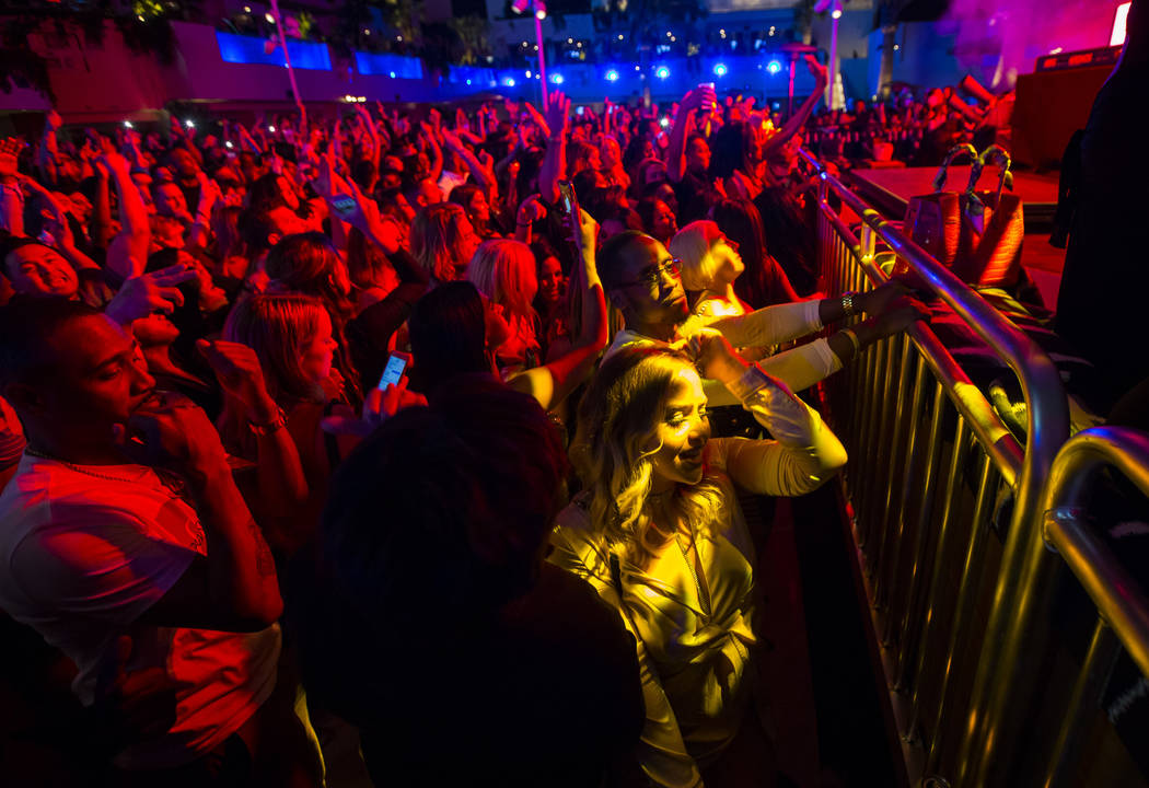 Attendees dance and listen to music as performers entertain by the outdoor stage during the gra ...