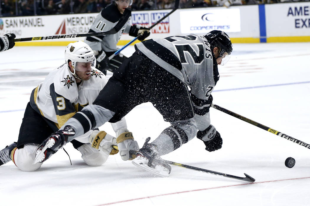 Los Angeles Kings forward Trevor Lewis (22) collides with Vegas Golden Knights defenseman Brayd ...