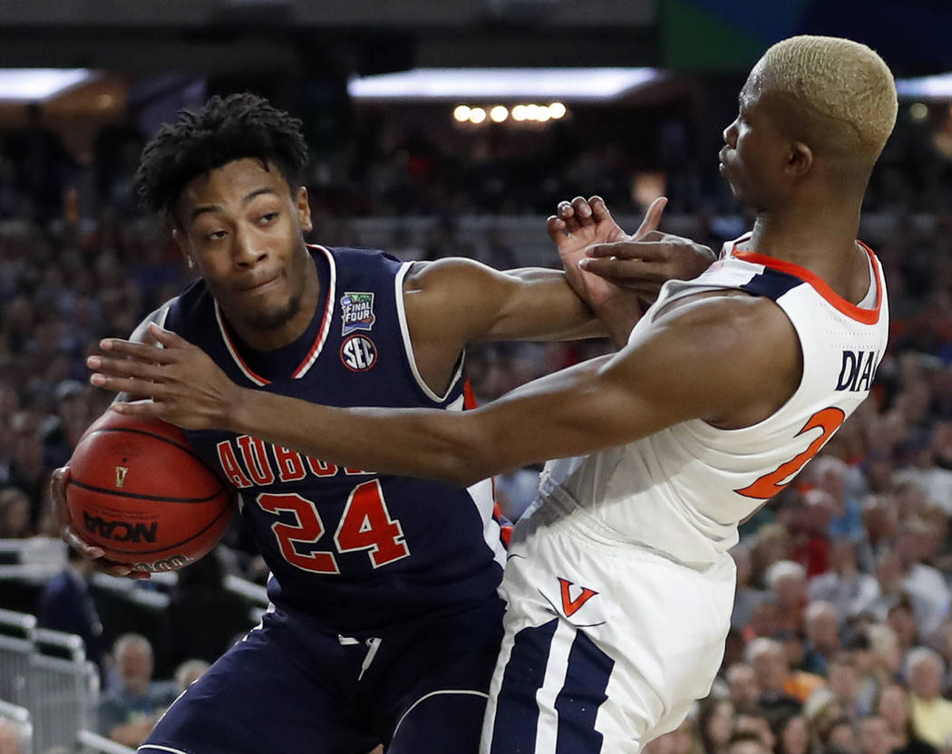 Auburn's Anfernee McLemore (24) battles for a loose ball against Virginia's Mamadi Diakite (25) ...