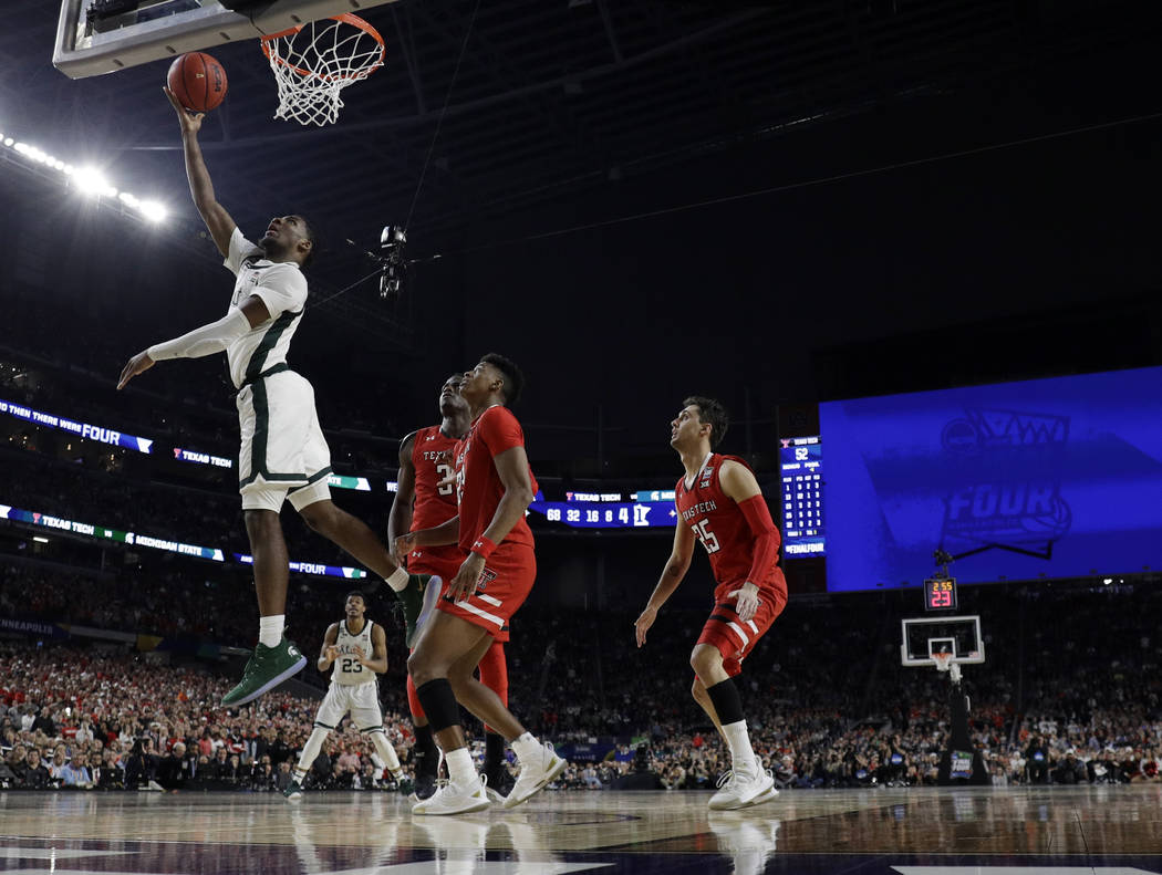 Michigan State's Aaron Henry (11) goes up for a basket during the second half in the semifinals ...