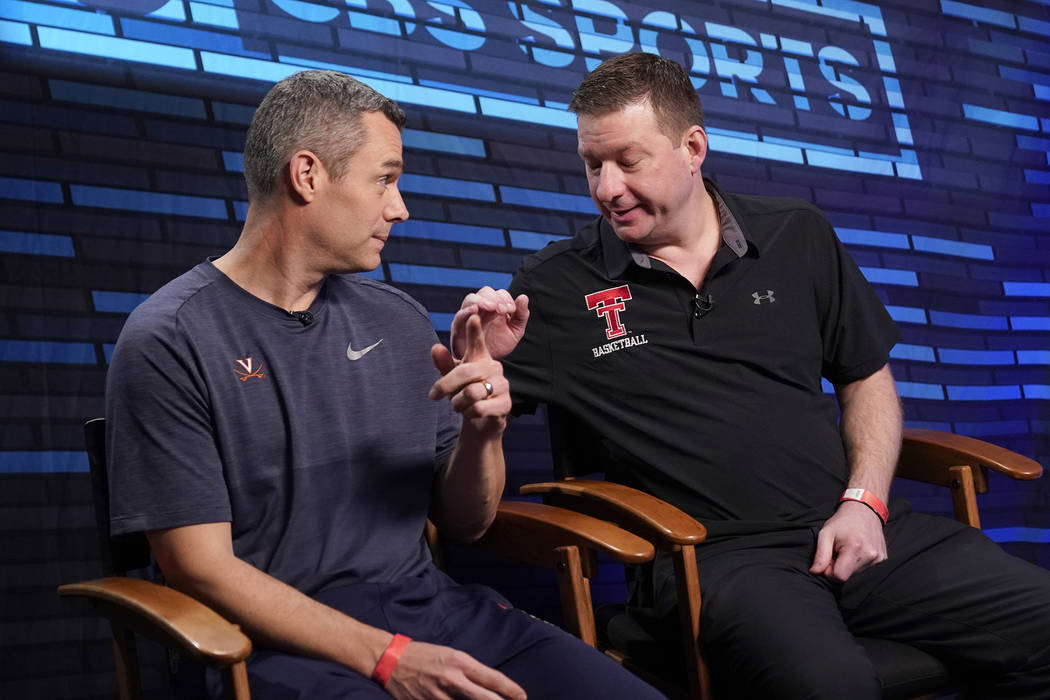 Virginia head coach Tony Bennett, left, and Texas Tech head coach Chris Beard talk after an int ...
