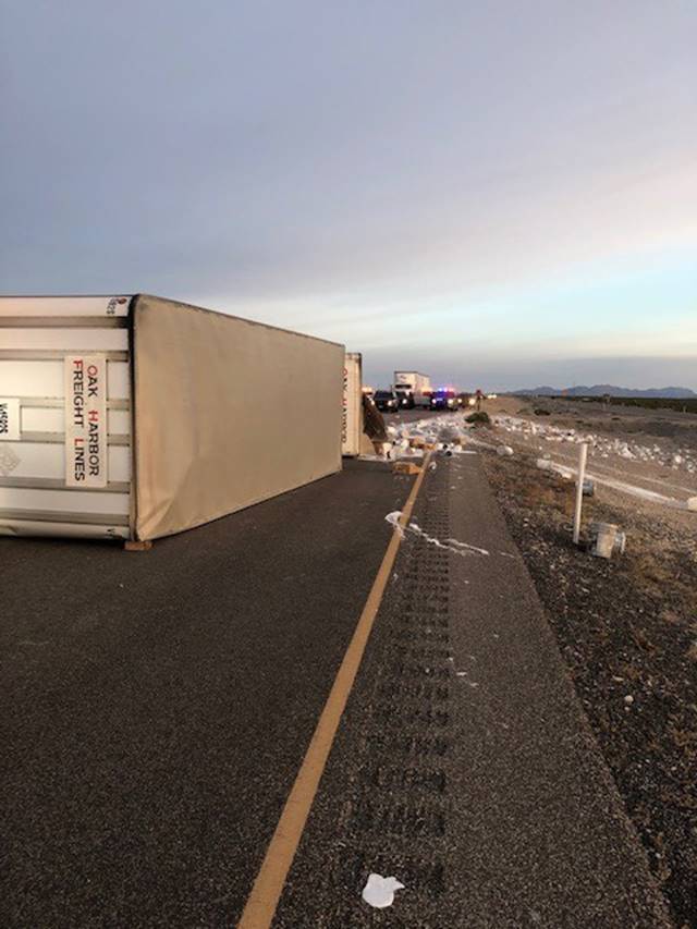 A tractor-trailer, which was hauling 1-gallon and 5-gallon buckets of paint, rolled over on U.S ...