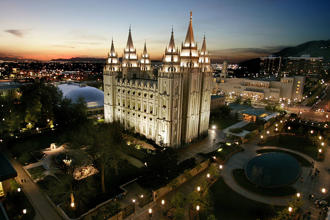 The sun sets behind the Mormon Temple, the centerpiece of Temple Square, in Salt Lake City in 2 ...