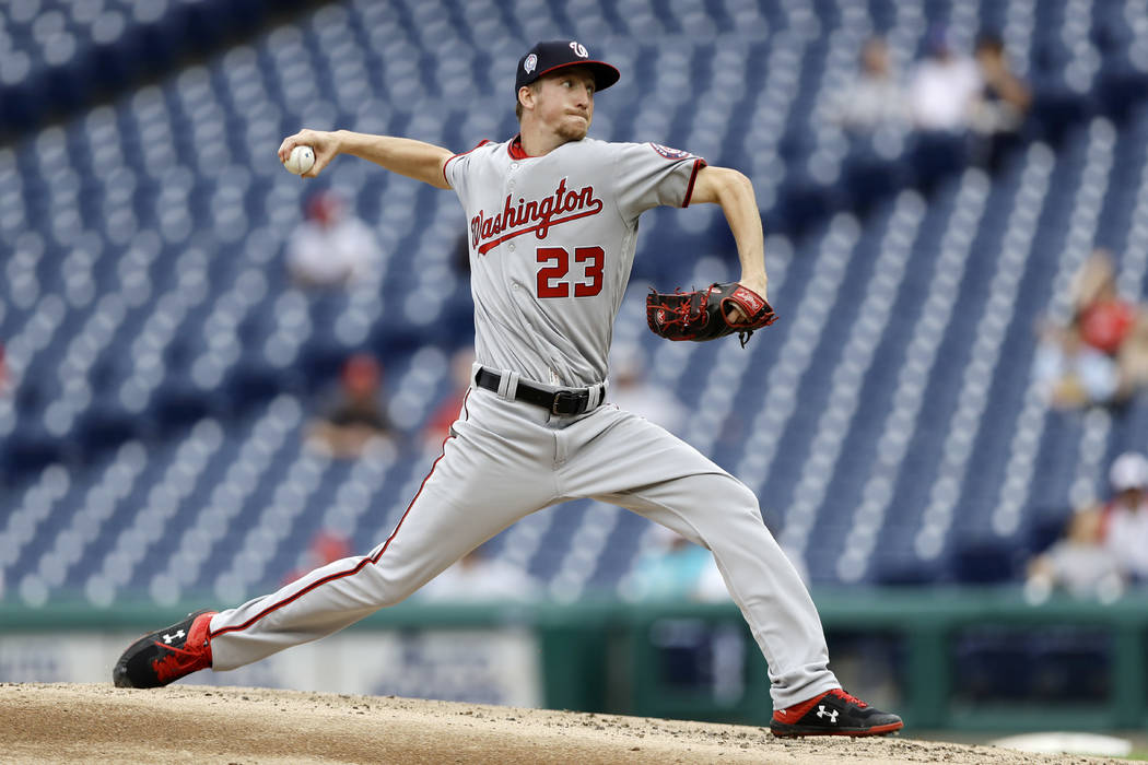 Washington Nationals' Erick Fedde pitches during the third inning of the first game of a baseba ...