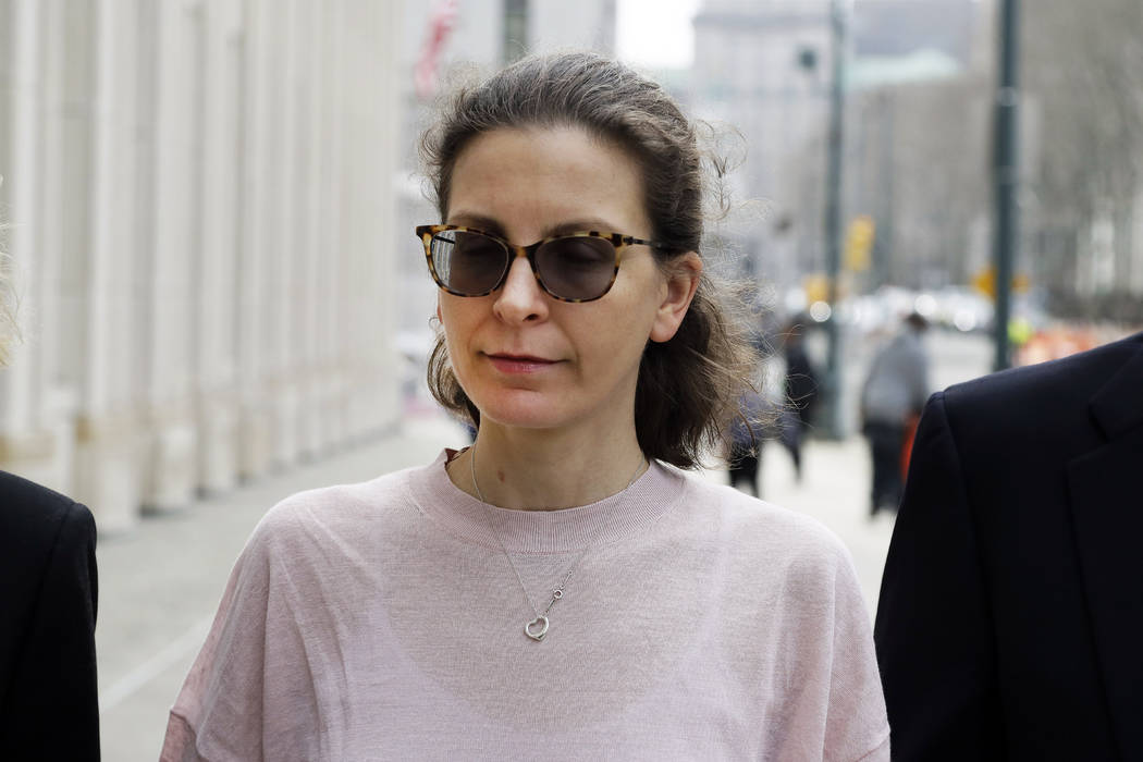 Clare Bronfman, center, a member of NXIVM, an organization charged with sex trafficking, arrive ...
