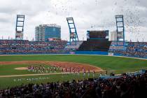 The Cuban national baseball team walks off the field as birds are released, at the start of the ...