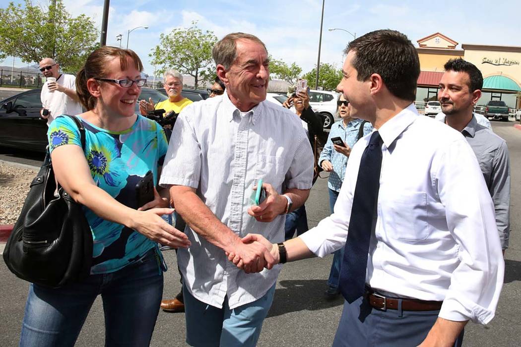 Indiana's South Bend Mayor Pete Buttigieg, right, is greeted by supporters as he arrives at Mad ...