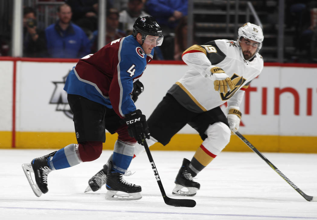 Colorado Avalanche defenseman Tyson Barrie, left, looks to shoot the puck past Vegas Golden Kni ...
