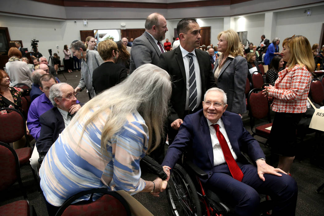 Former Sen. Harry Reid, greets Audrey Dempsey of Las Vegas before a panel on anti-Semitism in A ...