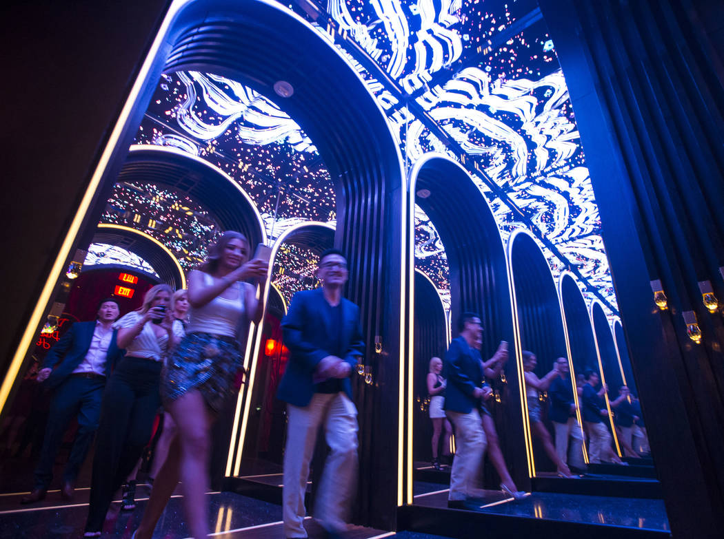 Attendees walk through a mirrored hallway to enter Kaos, the new dayclub and nightclub at the P ...