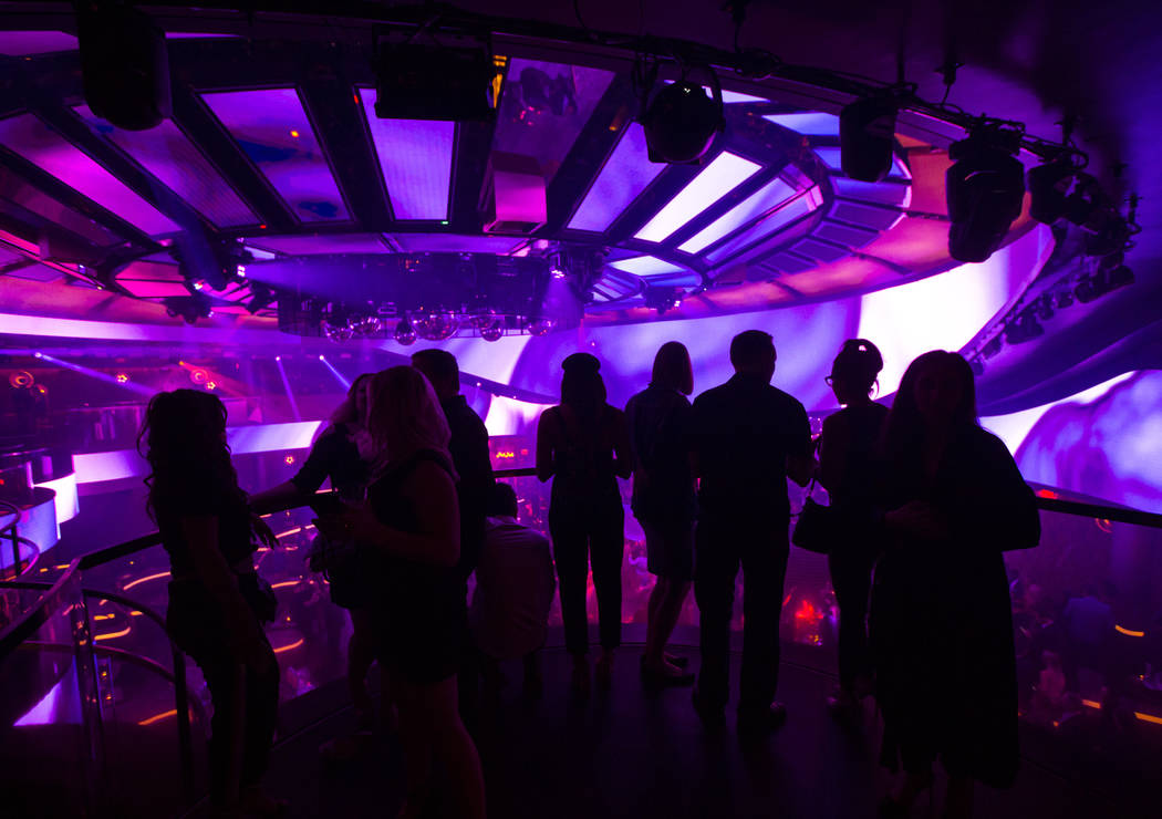 Attendees take in views of the nightclub from the mezzanine during the grand opening weekend of ...