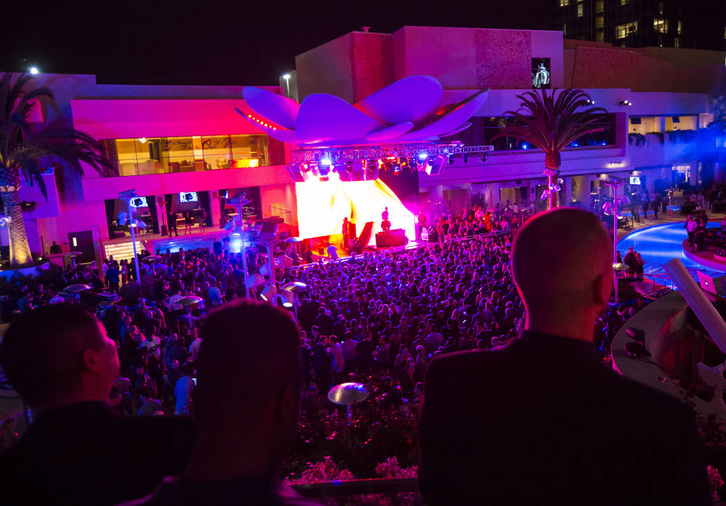 Attendees dance and listen to music during the grand opening weekend of Kaos, the new dayclub a ...