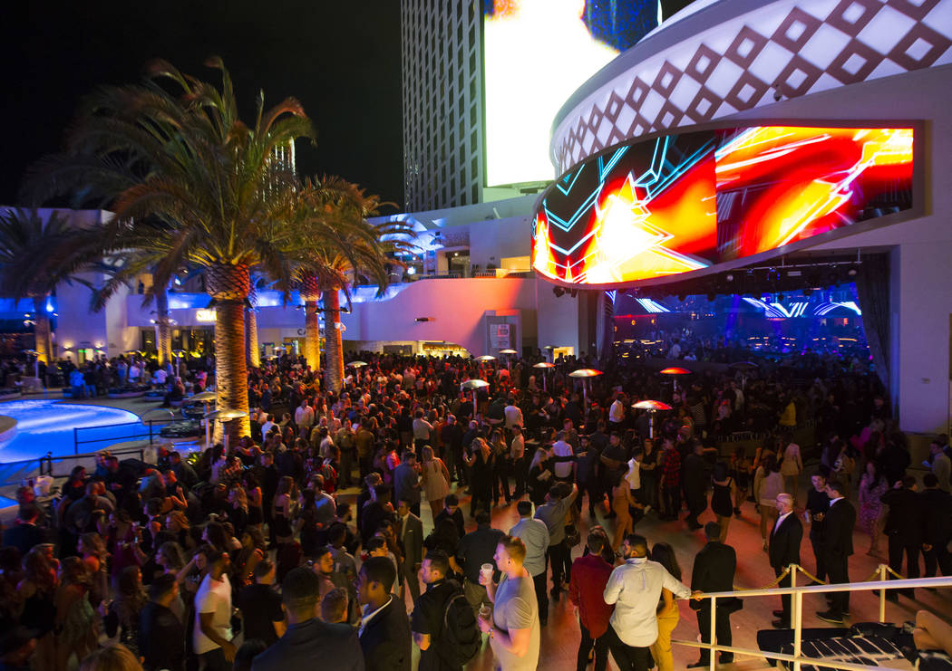 Attendees roam the outdoor area the during the grand opening weekend of Kaos, the new dayclub a ...