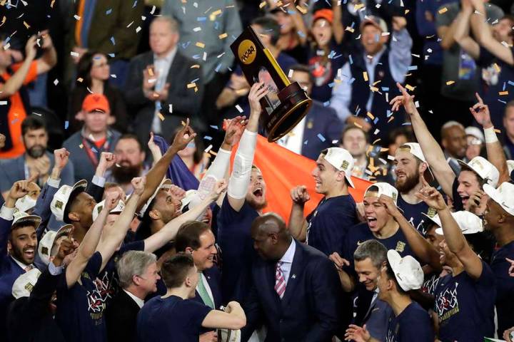 Virginia players celebrate with the trophy after defeating Texas Tech 85-77 in the championship ...