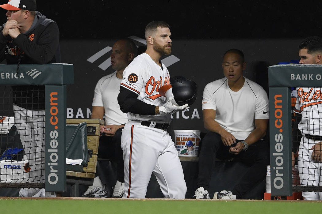 Baltimore Orioles' Chris Davis walks in the dugout after he lined out during the first inning o ...
