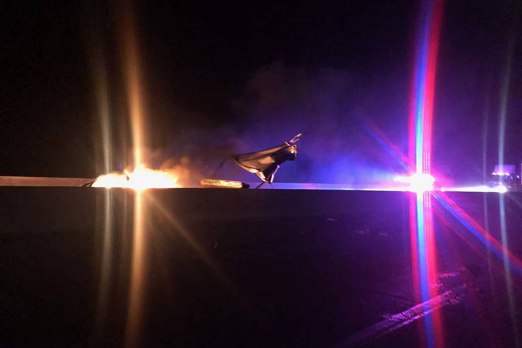 A vehicle burns as first responders arrive at a two-vehicle crash just a mile north of the Hoov ...