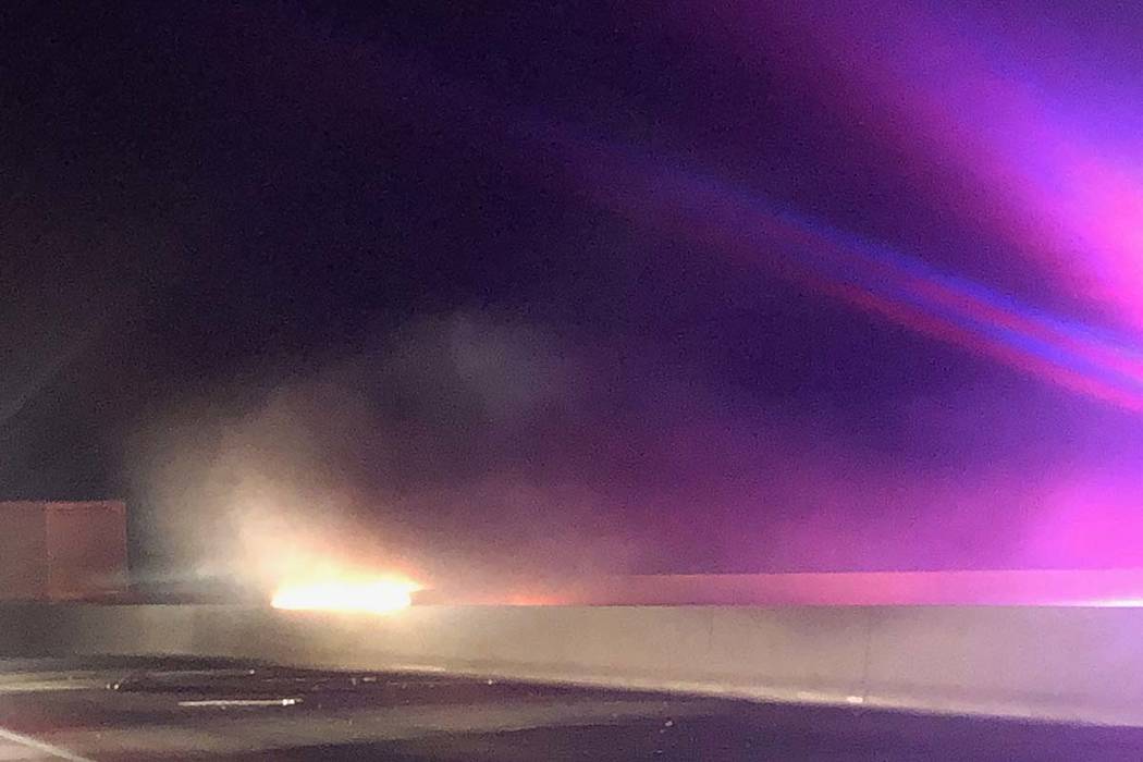 A vehicle burns as first responders arrive at a two-vehicle crash just a mile north of the Hoov ...