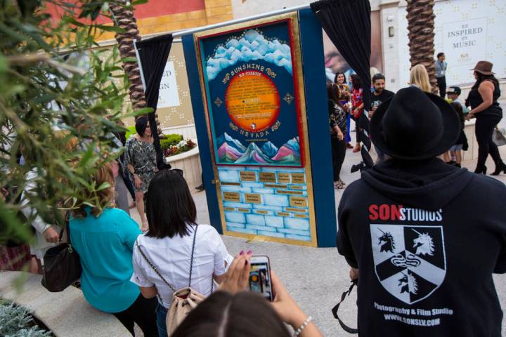 Attendees check out the Sunshine Nevada donor wall after it is unveiled at Tivoli Village in La ...