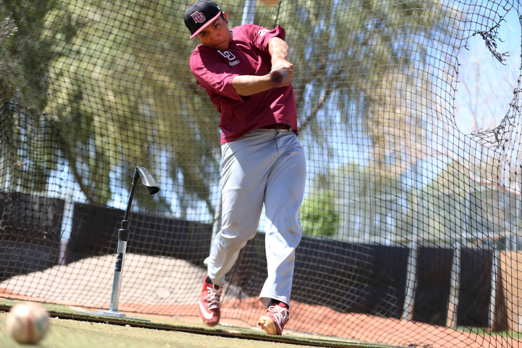 Desert Oasis senior Aaron Roberts, 18, hits the ball during a team practice at Desert Oasis Hig ...