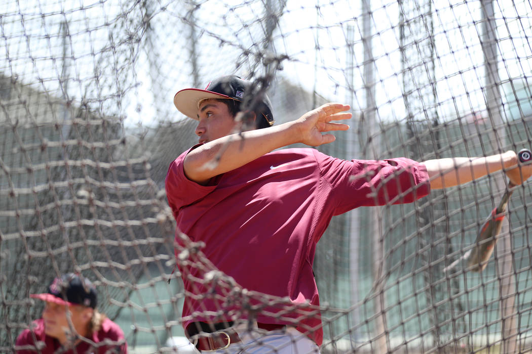 Desert Oasis senior Aaron Roberts, 18, hits the ball during a team practice at Desert Oasis Hig ...