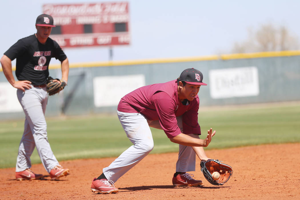 Desert Oasis senior Aaron Roberts, 18, catches a ground ball during a team practice at Desert O ...
