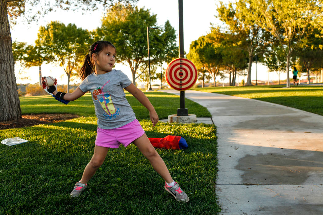 Hailey Dawson, who has a 3-D prosthetic hand, works on her delivery on Thursday, Oct. 19, 2017, ...