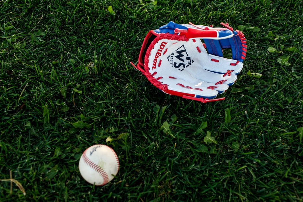 A World Series themed baseball glove belonging to Hailey Dawson of Henderson, lays on the groun ...
