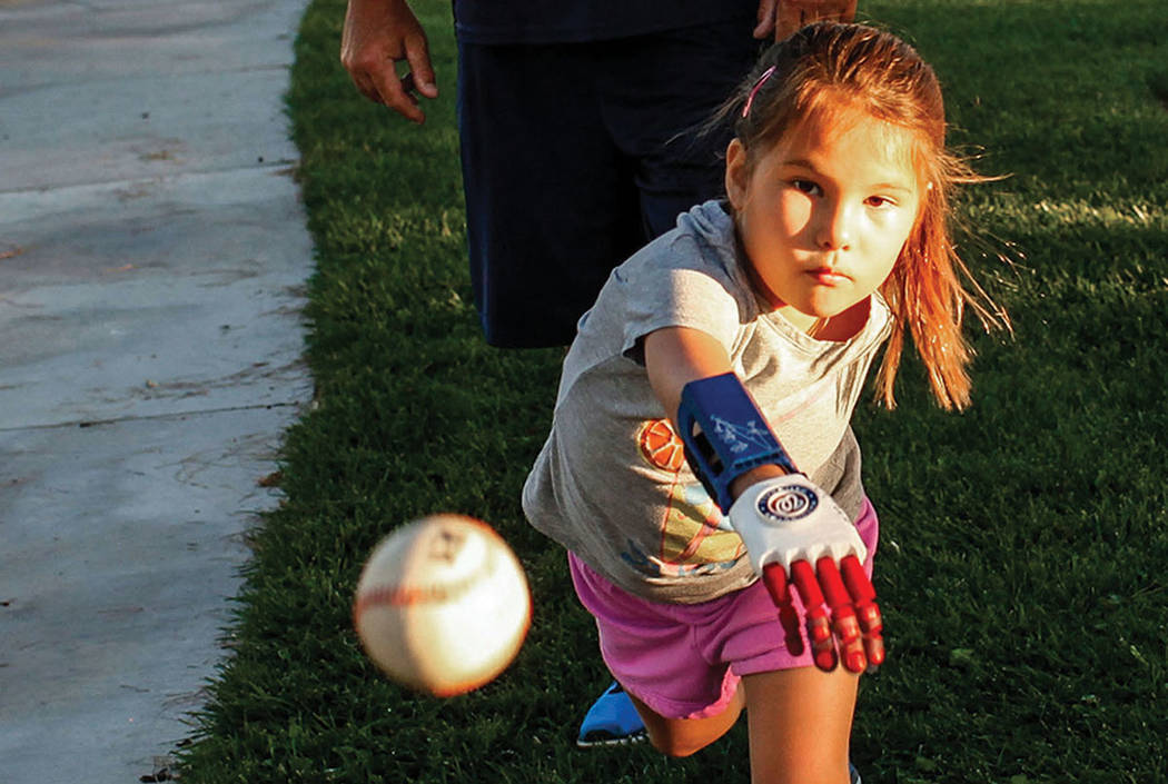 Hailey Dawson, who has a 3-D prosthetic hand, works on her delivery on Thursday, Oct. 19, 2017, ...