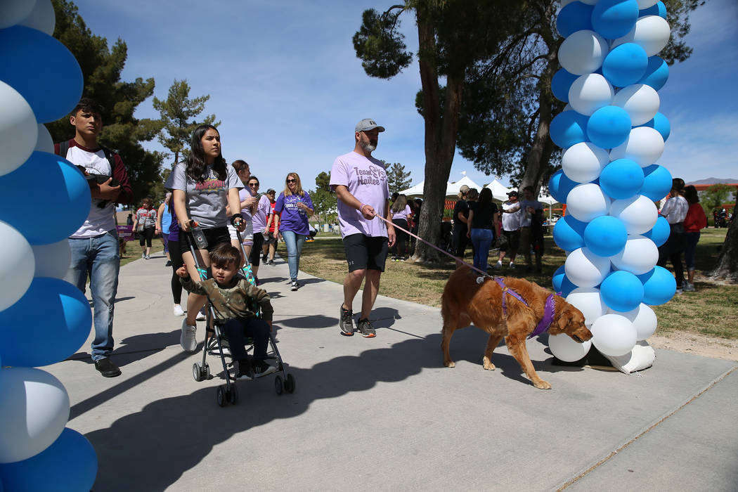 People participate during the Out of the Darkness Community Walk at Craig Ranch Regional Park i ...
