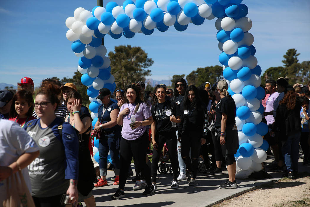 People participate during the Out of the Darkness Community Walk at Craig Ranch Park in North L ...