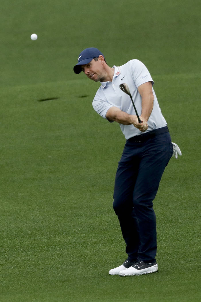 Rory McIlroy, of Northern Ireland, hits from the fairway on the second hole during a practice r ...