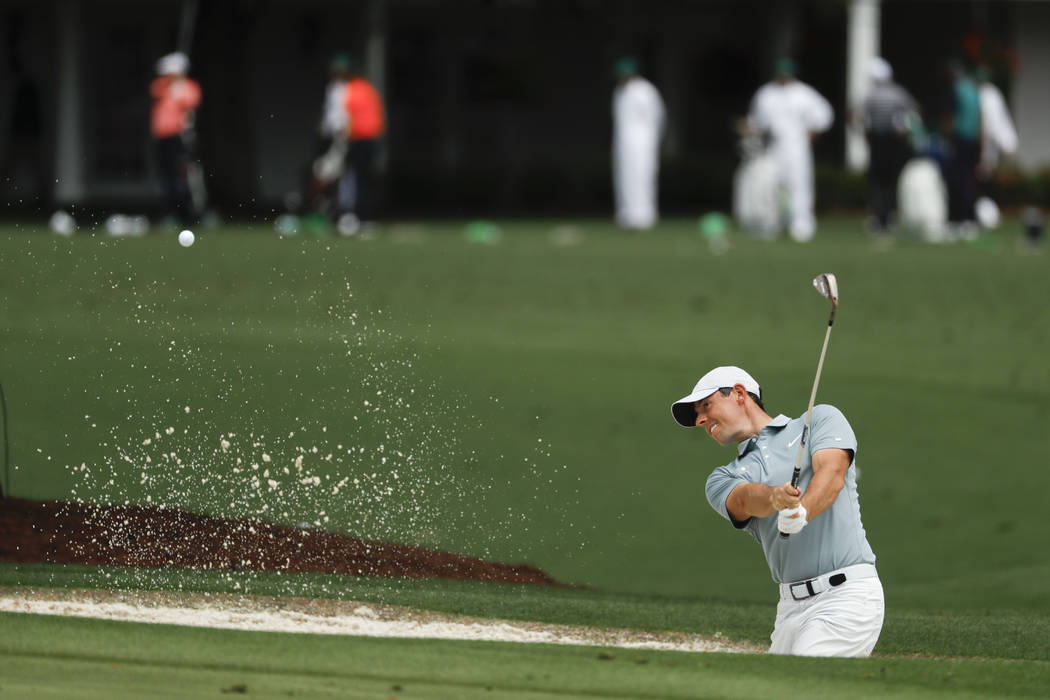 Rory McIlroy, of Northern Ireland, practices on the driving range at the Masters golf tournamen ...