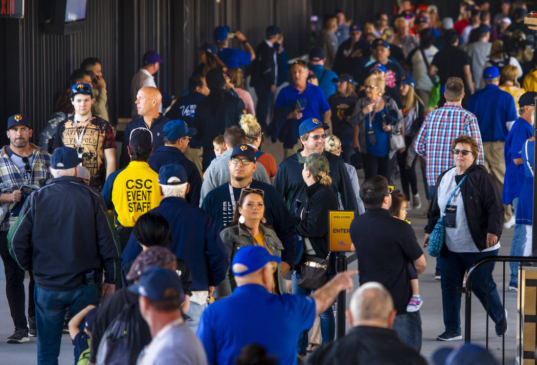 Fans stream along inside the ballpark before the Las Vegas Aviators home opener on Tuesday, Apr ...