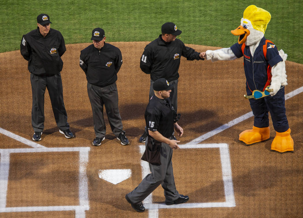 Umpires meet at home plate and are greeted by Spruce before the start of the Las Vegas Aviators ...