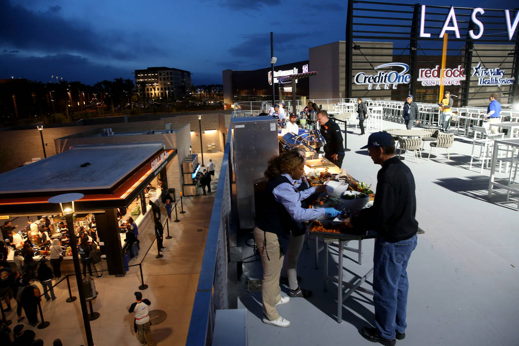 Fans grab food on the first-ever opening night for the Las Vegas Aviators at Las Vegas Ballpark ...