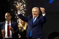 Israel's Prime Minister Benjamin Netanyahu waves to his supporters after polls for Israel's gen ...