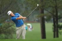 Charley Hoffman hits from the fairway in the rain on the first hole during a practice round for ...
