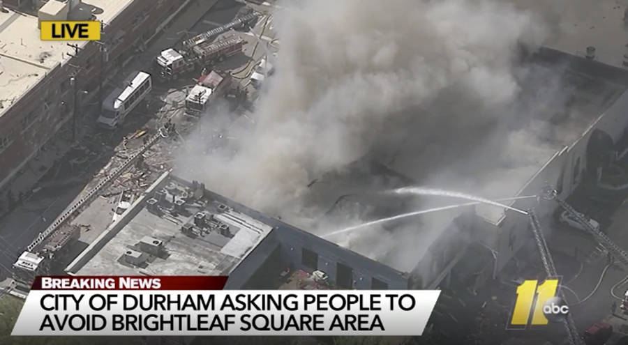 In this image made from video and provided by WTVD-TV Durham, firefighters spray water on a bui ...