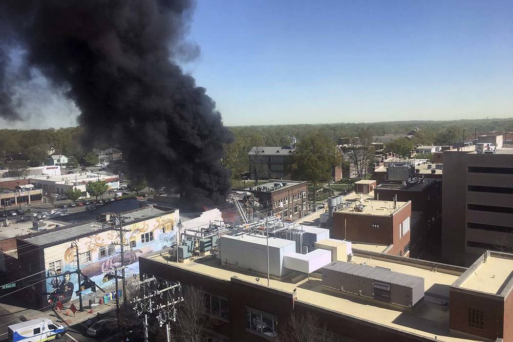 Smoke billows from the scene of an explosion and fire in downtown Durham, N.C. Wednesday, April ...